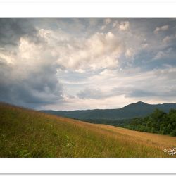 Storm clouds bubble up over a Cades Cove grassy meadow, Great Sm